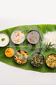 South IndianÂ style lunch or dinner meal or food served with a selection of recipes over banana leaf